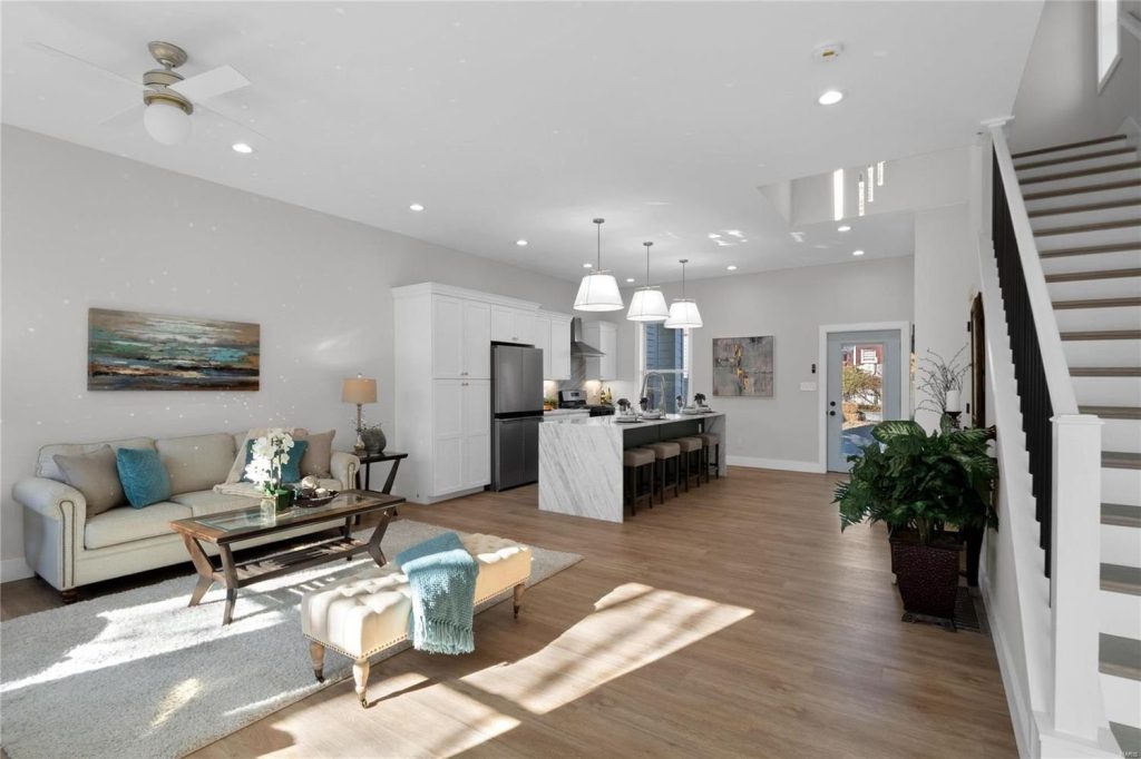 Open living area with staircase and kitchen beyond