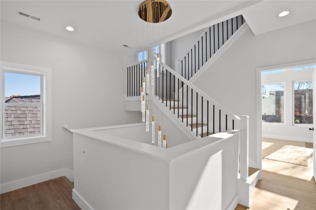 Entry hall with staircase and ring chandelier