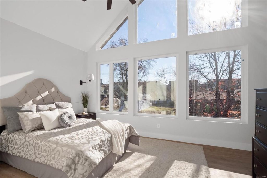 Bedroom with vaulted ceiling and floor to ceiling windows