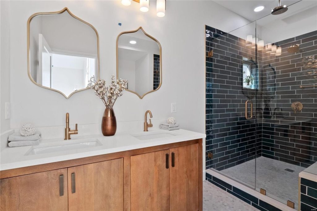 Bathroom with wood double vanity and glass shower