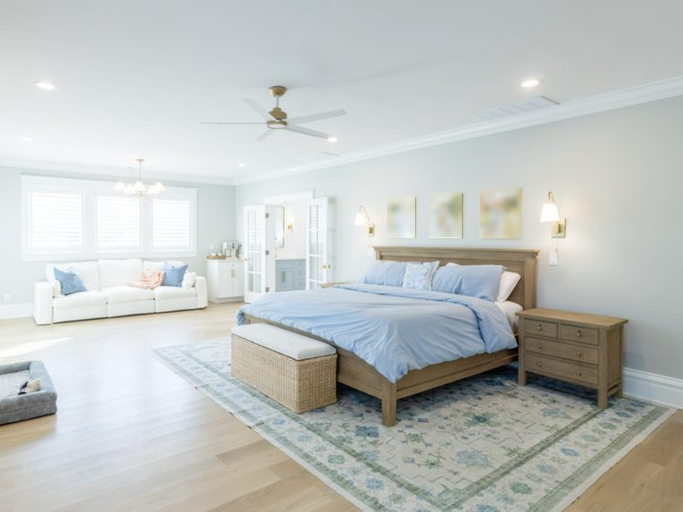 Primary bedroom suite with a bench at the foot of the bed