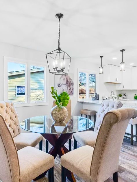 Dining room with a lantern pendant and upholstered chairs