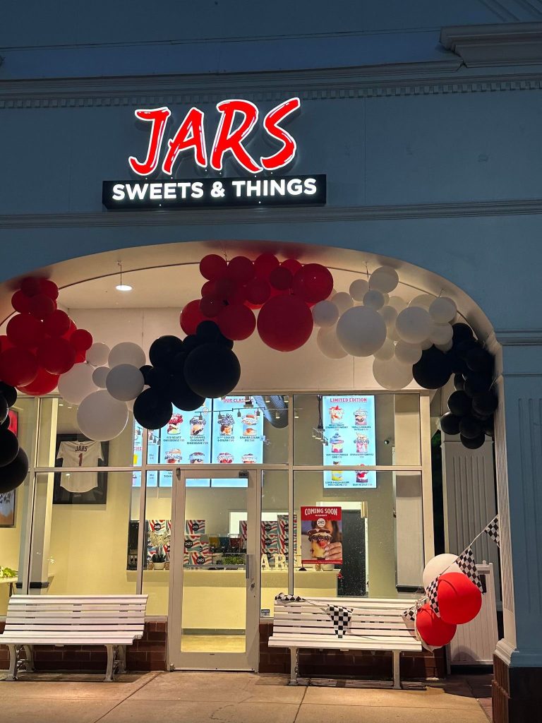 Entrance archway with red and black balloon display