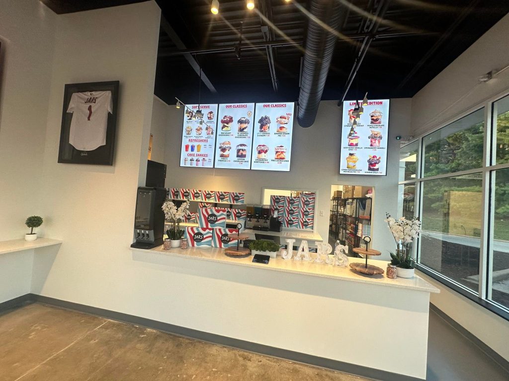 Service counter with menu screens and window seating