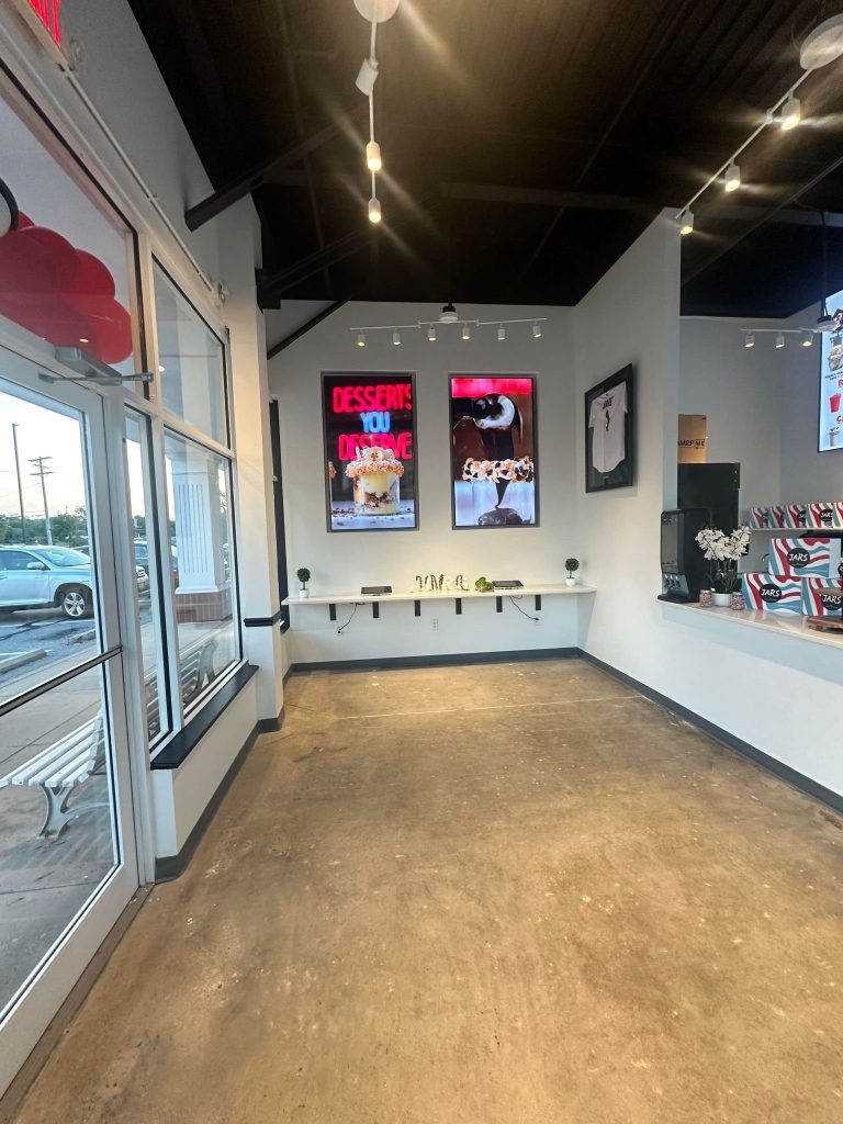 Retail floor with framed artwork and window bench