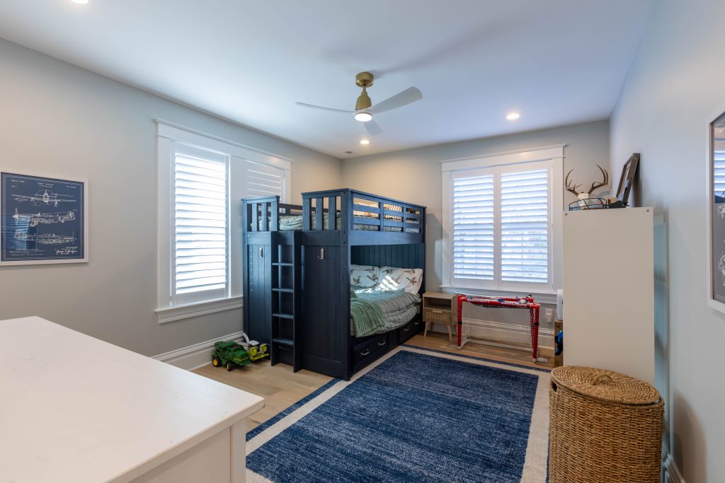 Children's bedroom with navy bunk beds and plantation shutters