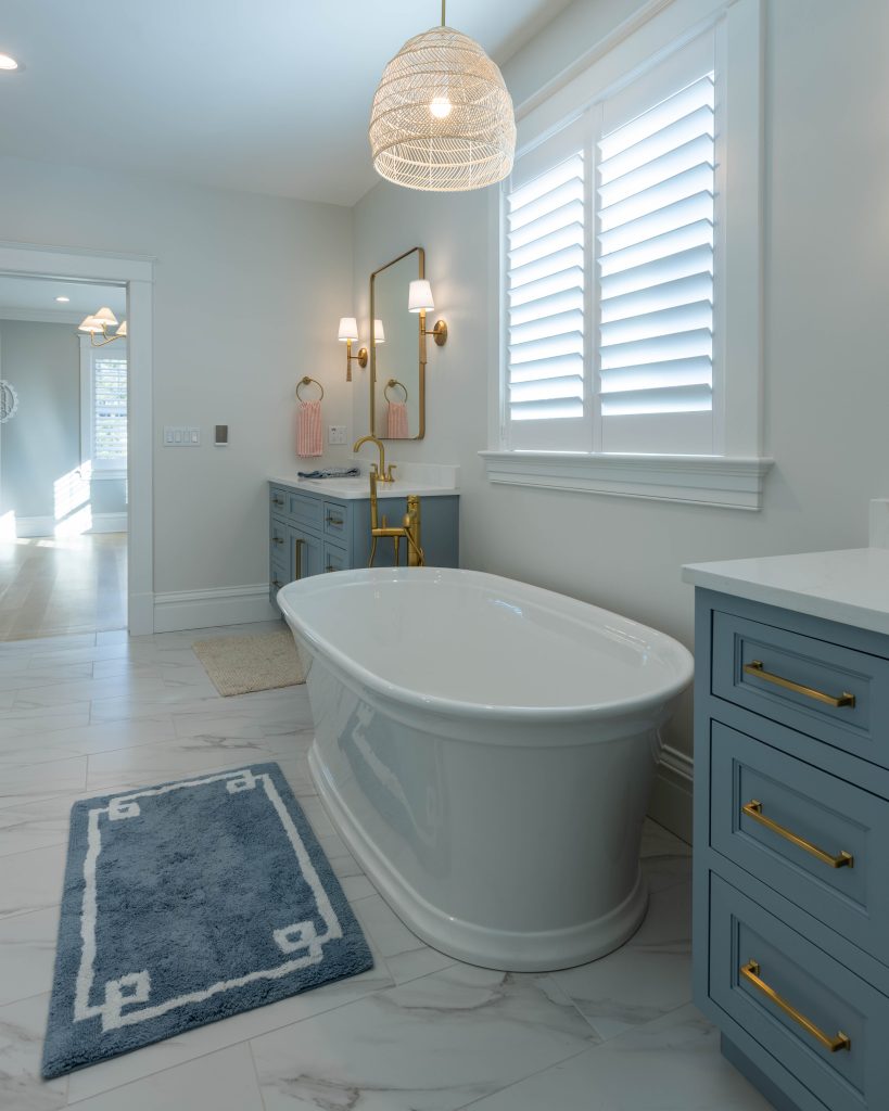 Primary bath tub with a view through to the bedroom
