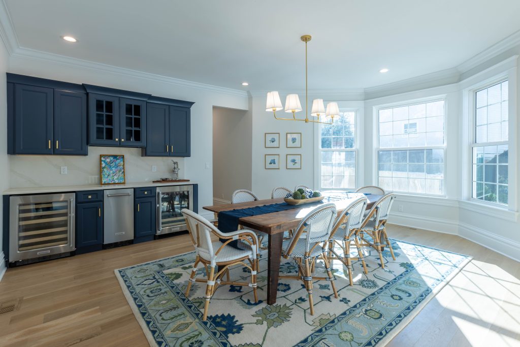 Dining room with navy bar cabinetry and wine refrigerators