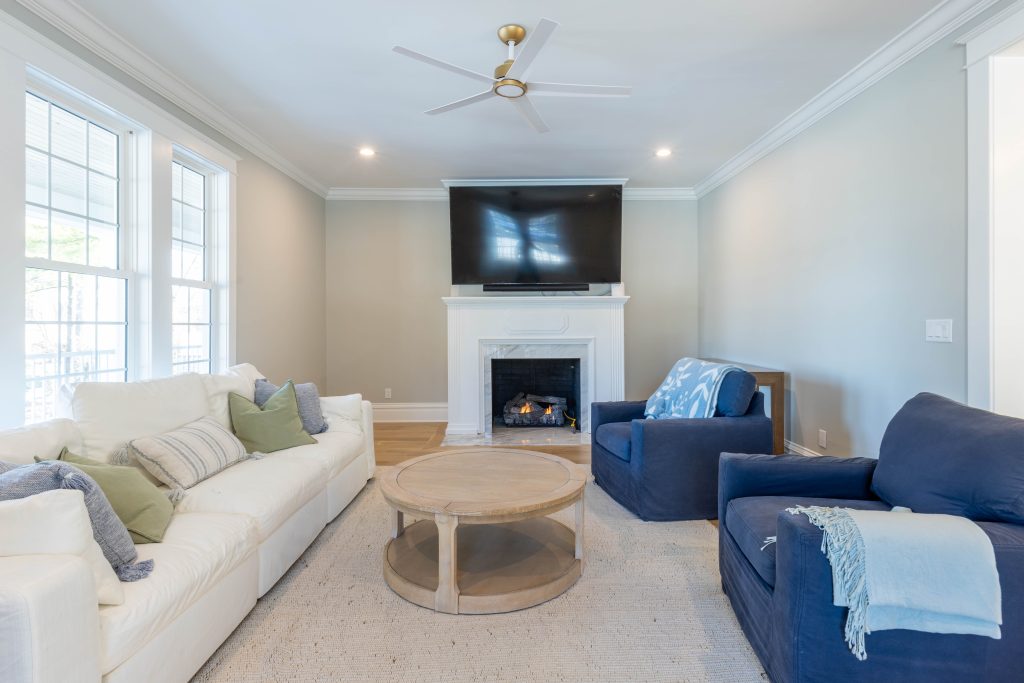 Living room with marble fireplace and slipcovered seating