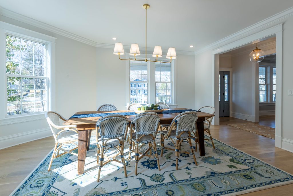 Dining room with farm table and rattan bistro chairs