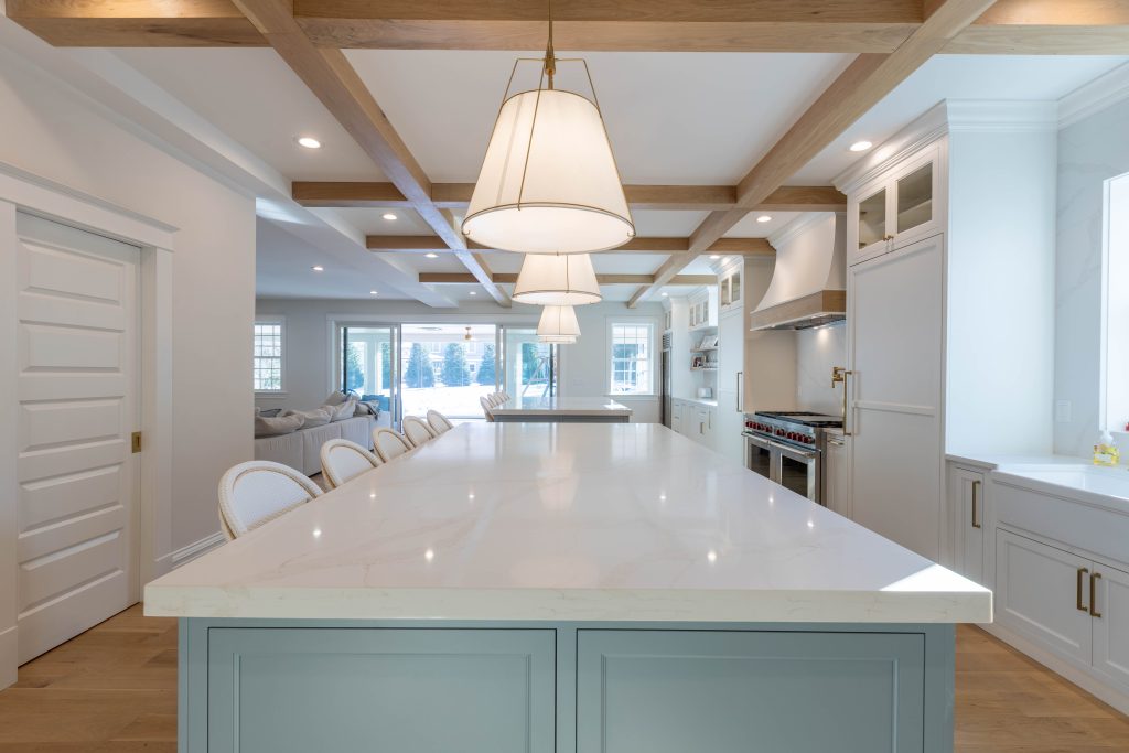 Marble-topped island facing the range and plaster hood