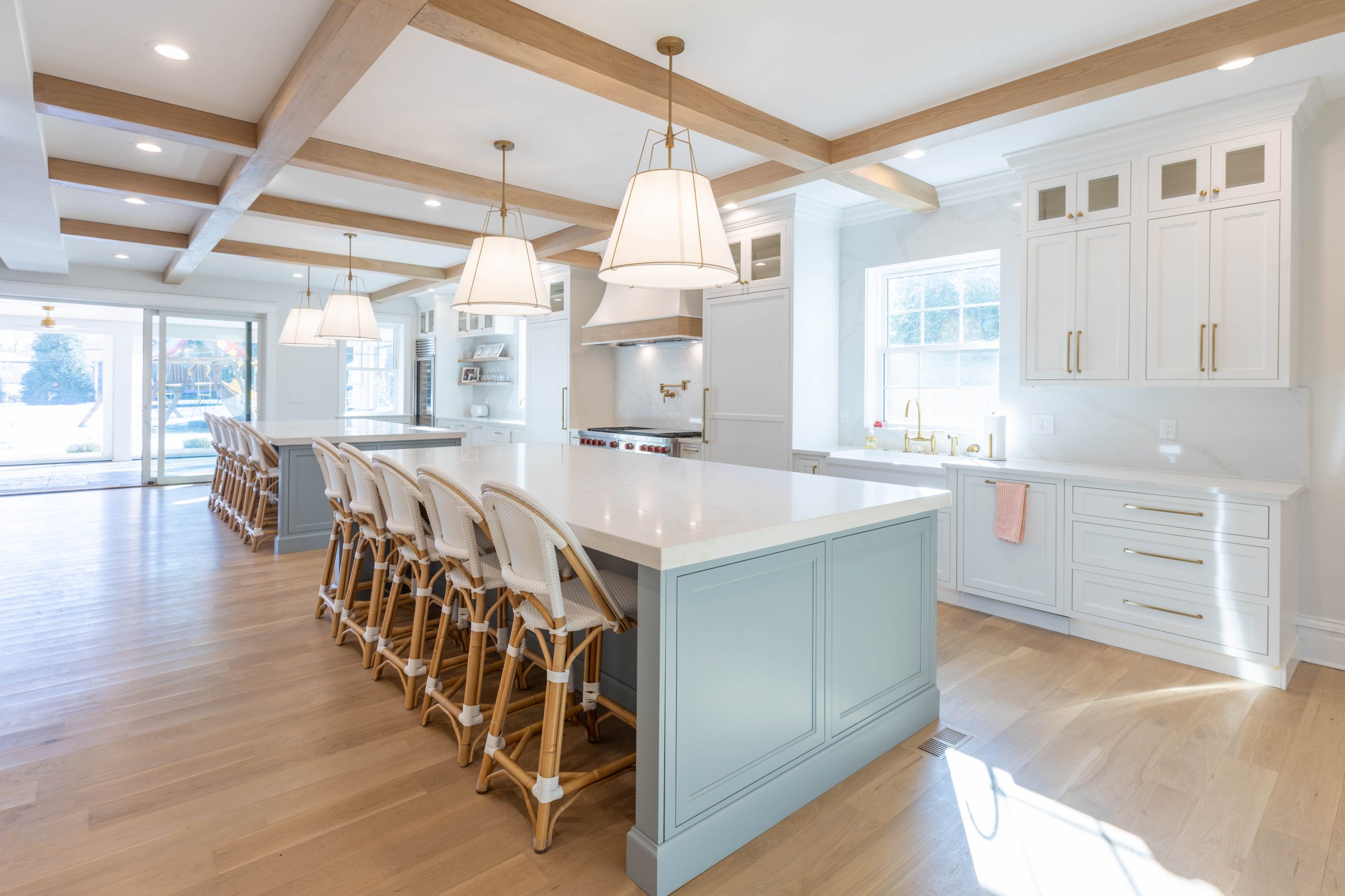 Twin kitchen islands with rattan counter stools