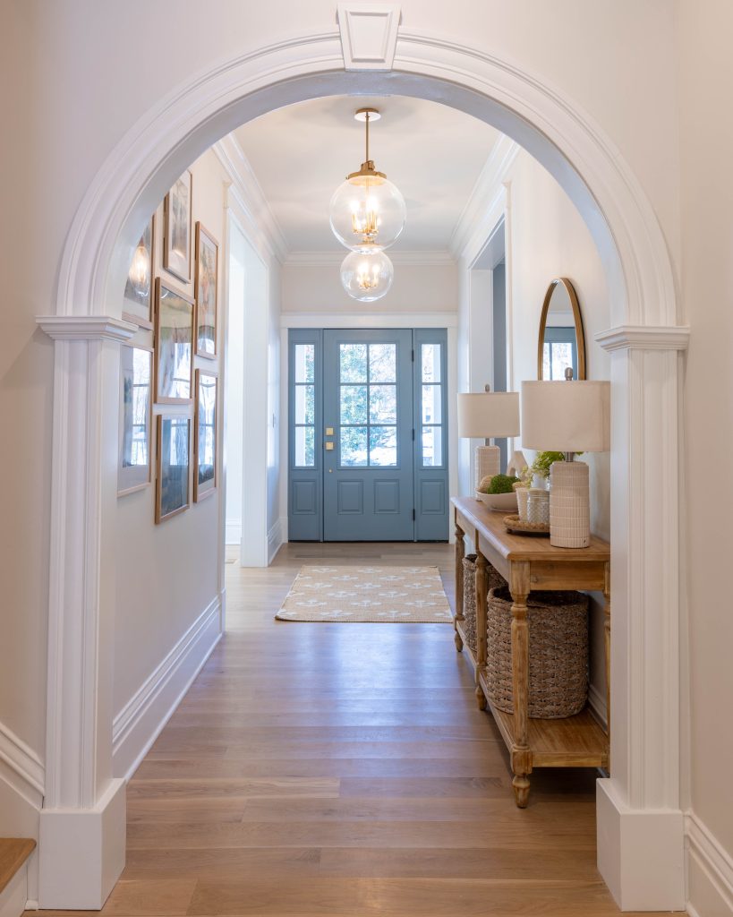 Arched hallway framing the blue front door