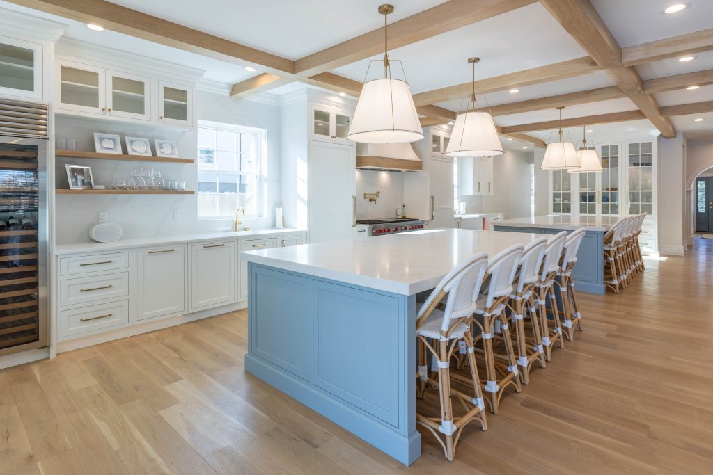 Kitchen island with white cabinetry and floating shelves