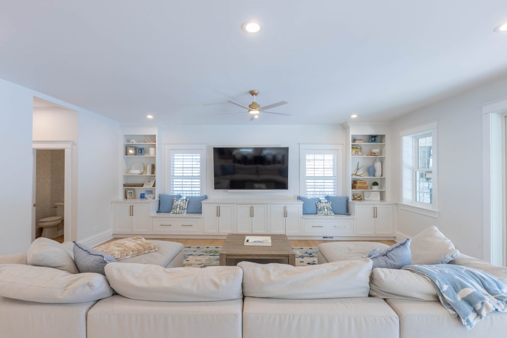 Built-in cabinetry and window seats flanking the TV