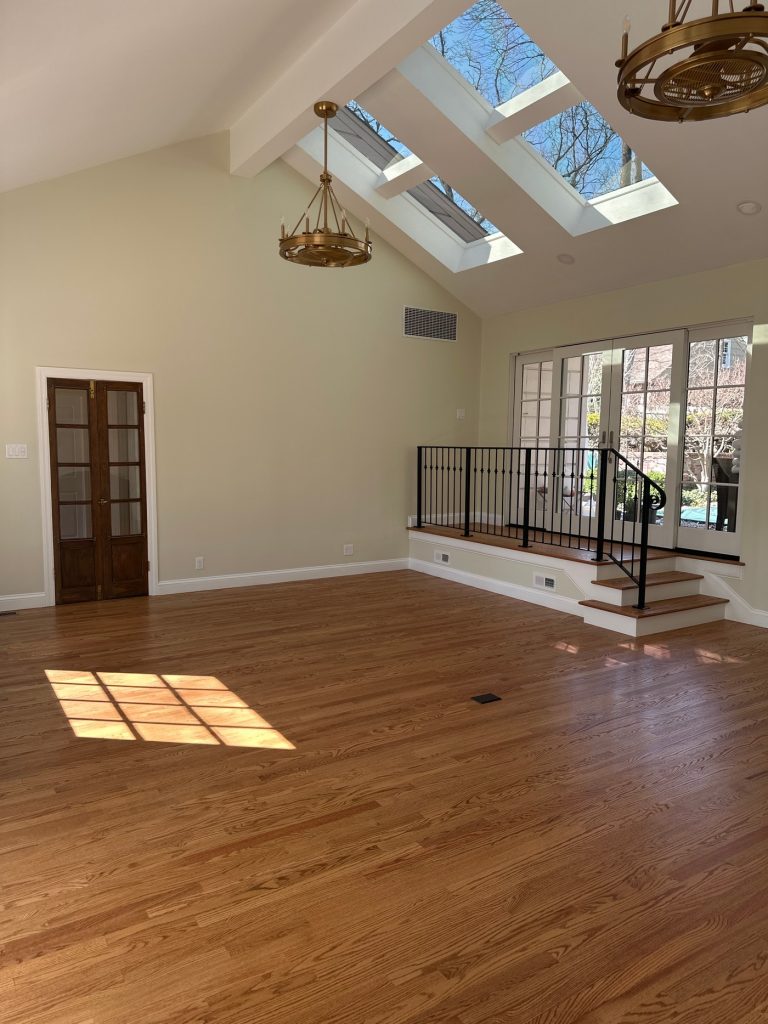 Vaulted room with skylights and French doors to the patio