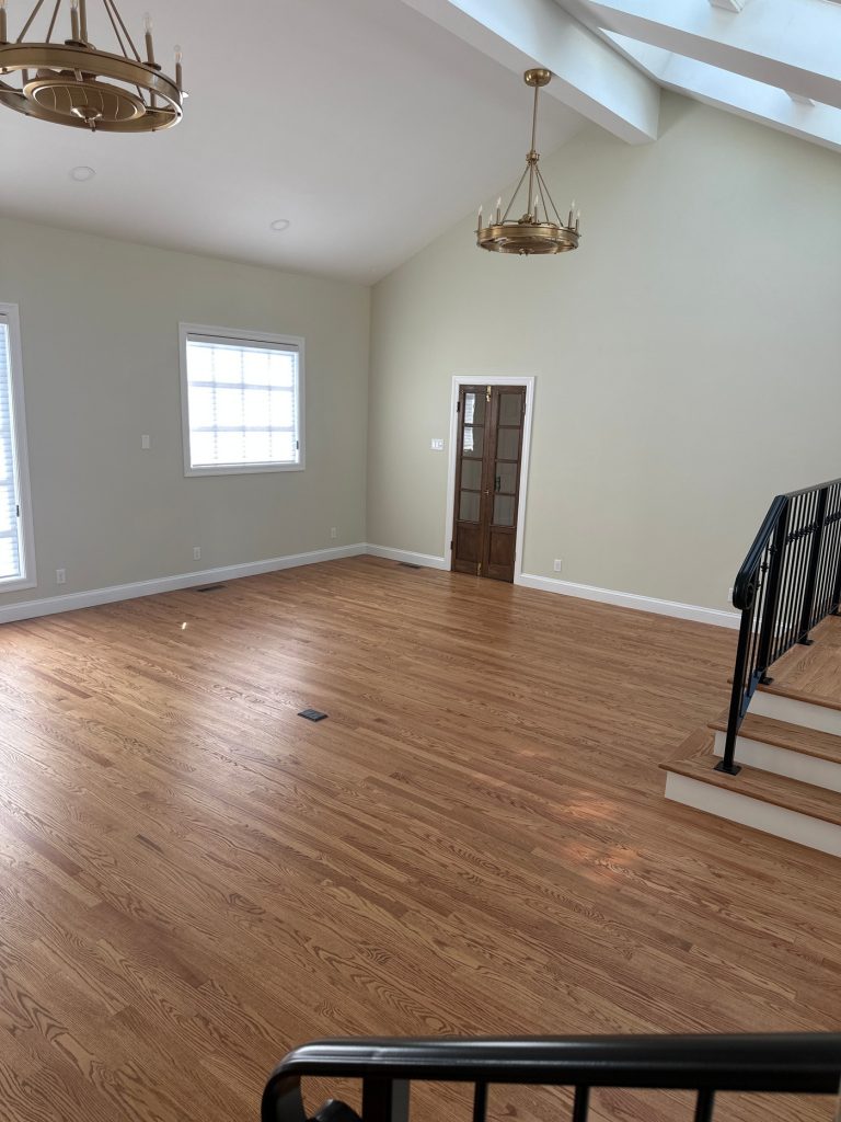 Empty room with stained French doors and floor outlets