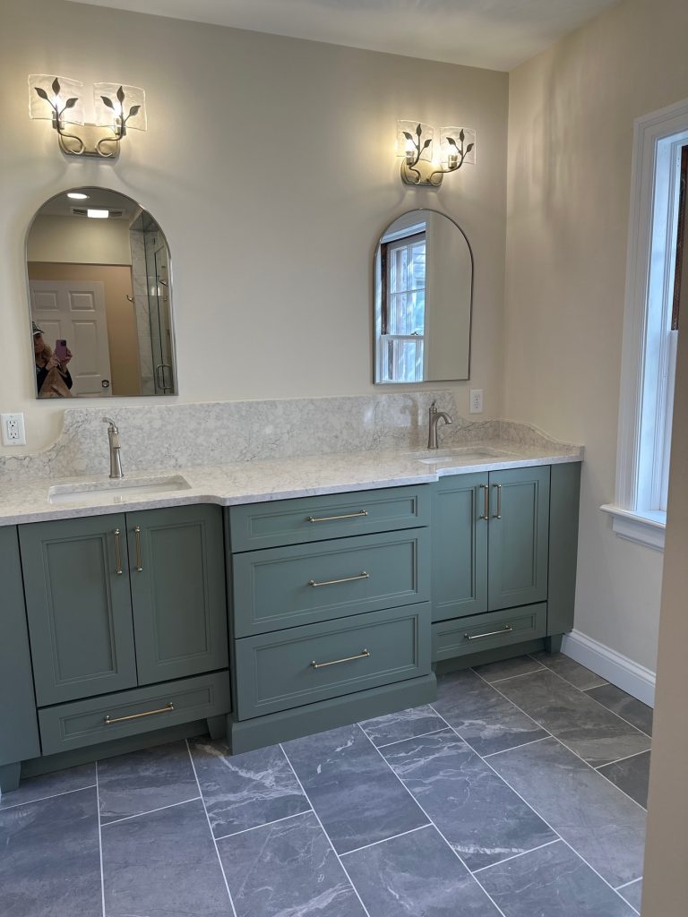 Green double vanity with arched mirrors and quartz top