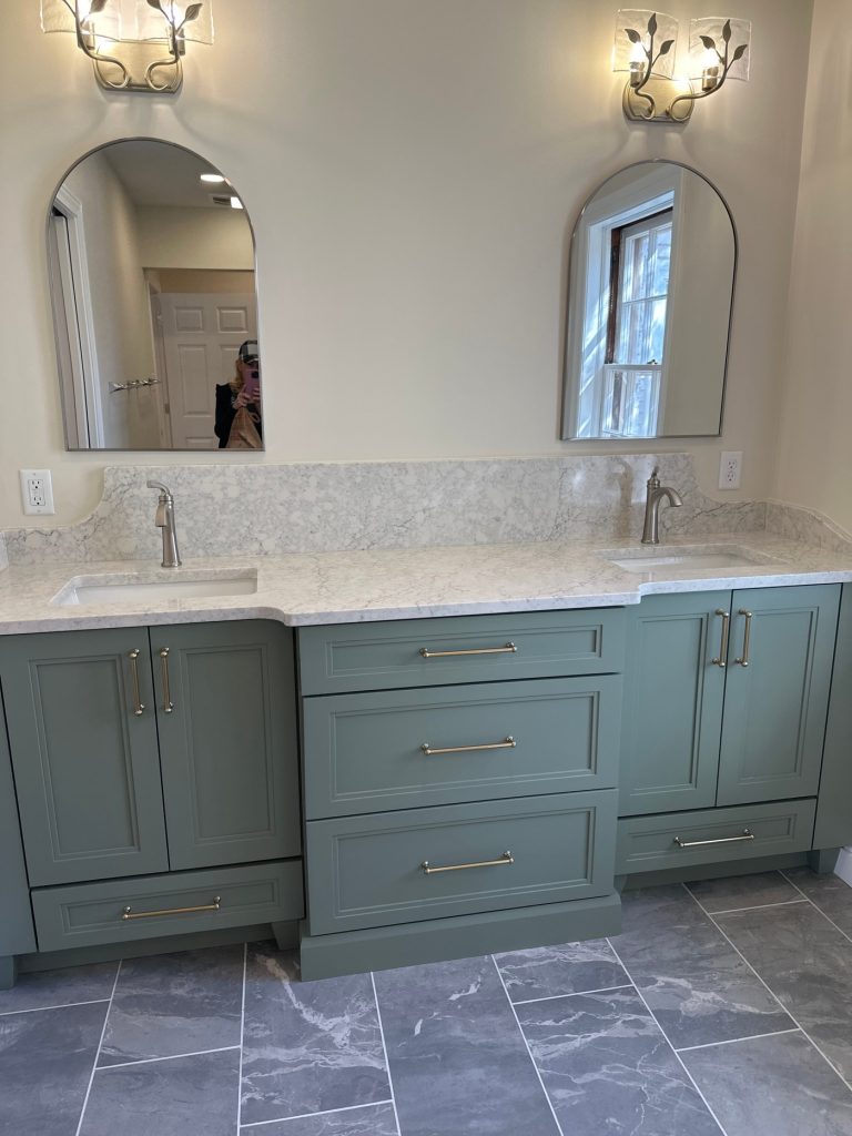 Double vanity with brass hardware and marble-look tile