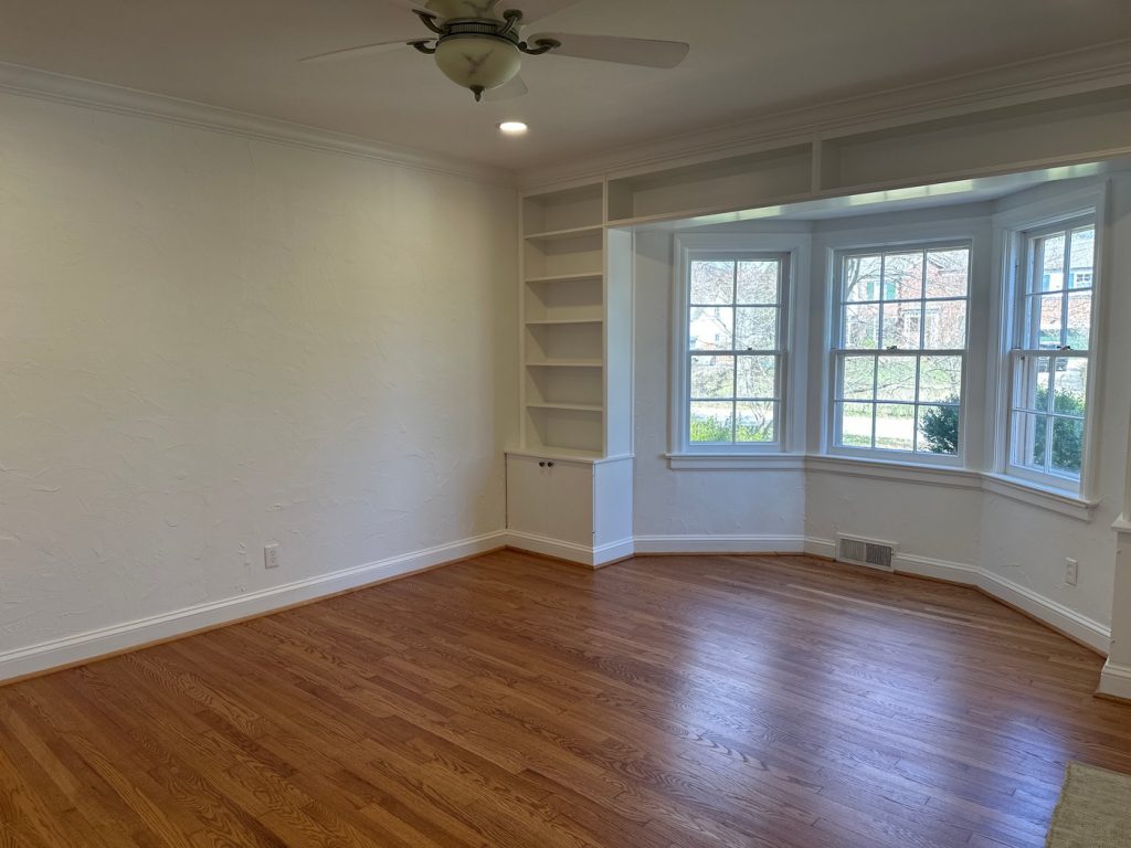 Room with bay window and built-in bookshelves