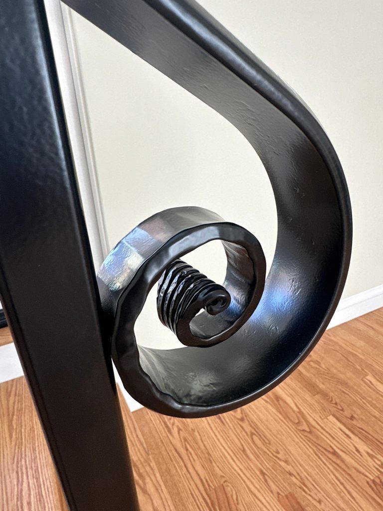 Detail of the hand-forged iron railing volute