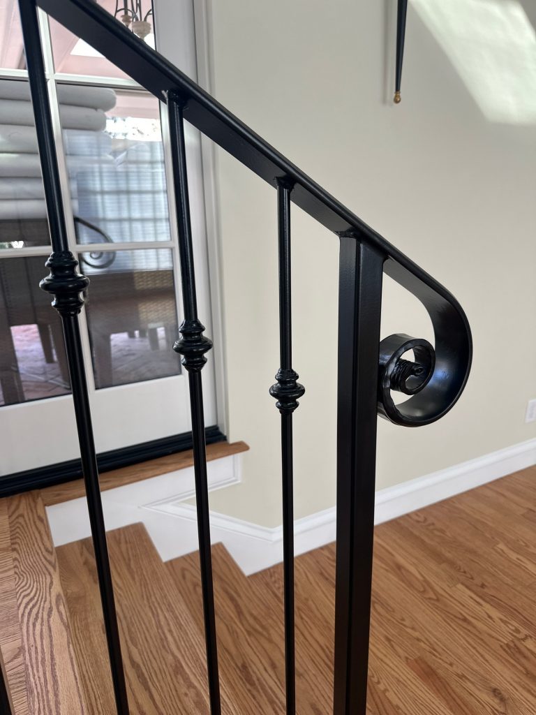 Iron balusters with decorative knuckles and scrolled end