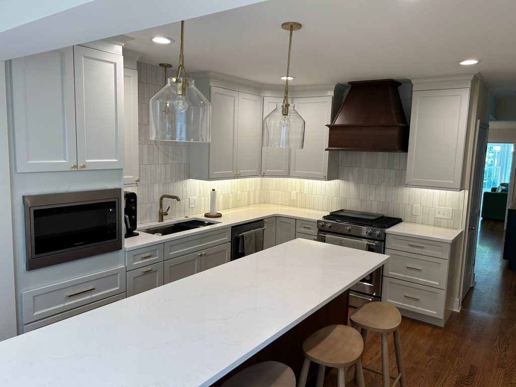 Kitchen with gas range and vertical tile backsplash