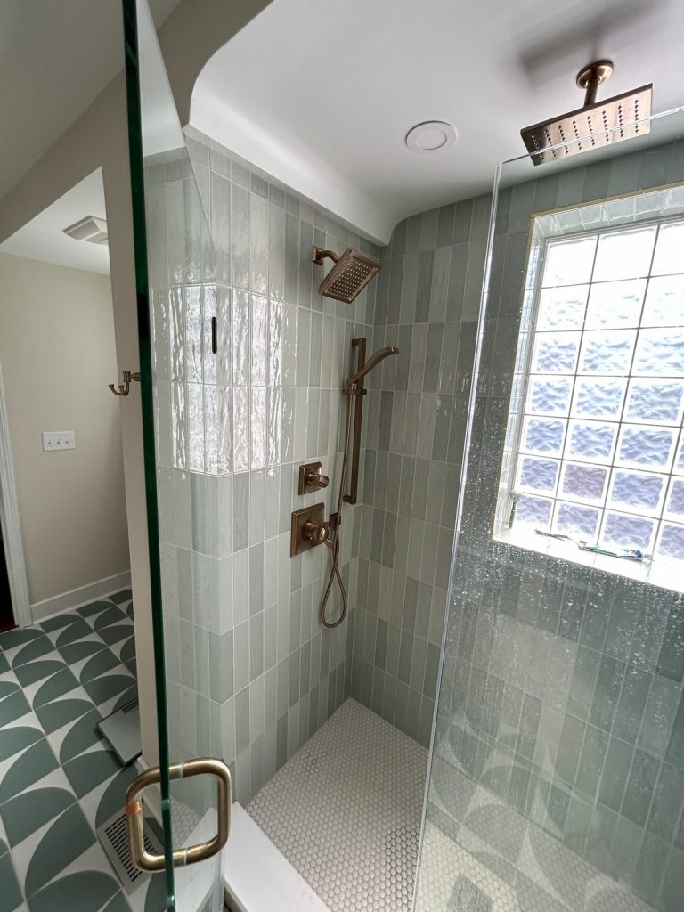 Green-tiled shower with glass block window