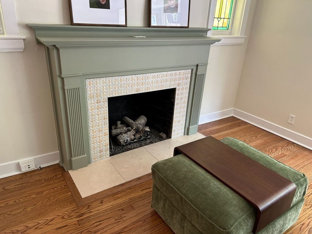 Sage painted fireplace with tiled surround