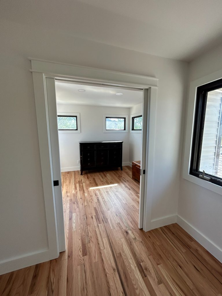 Wide cased opening looking into the bedroom