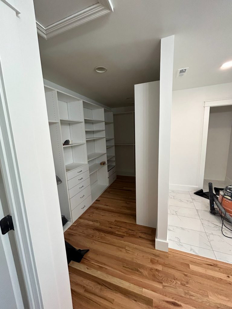 Walk-in closet with adjustable white shelving