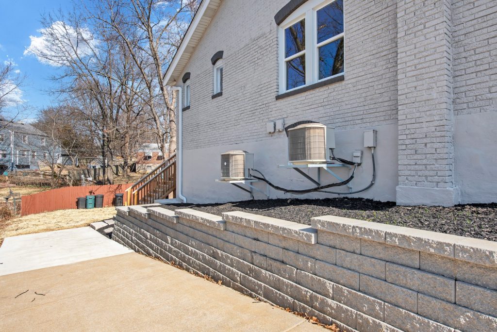 Side elevation with new HVAC units and retaining wall