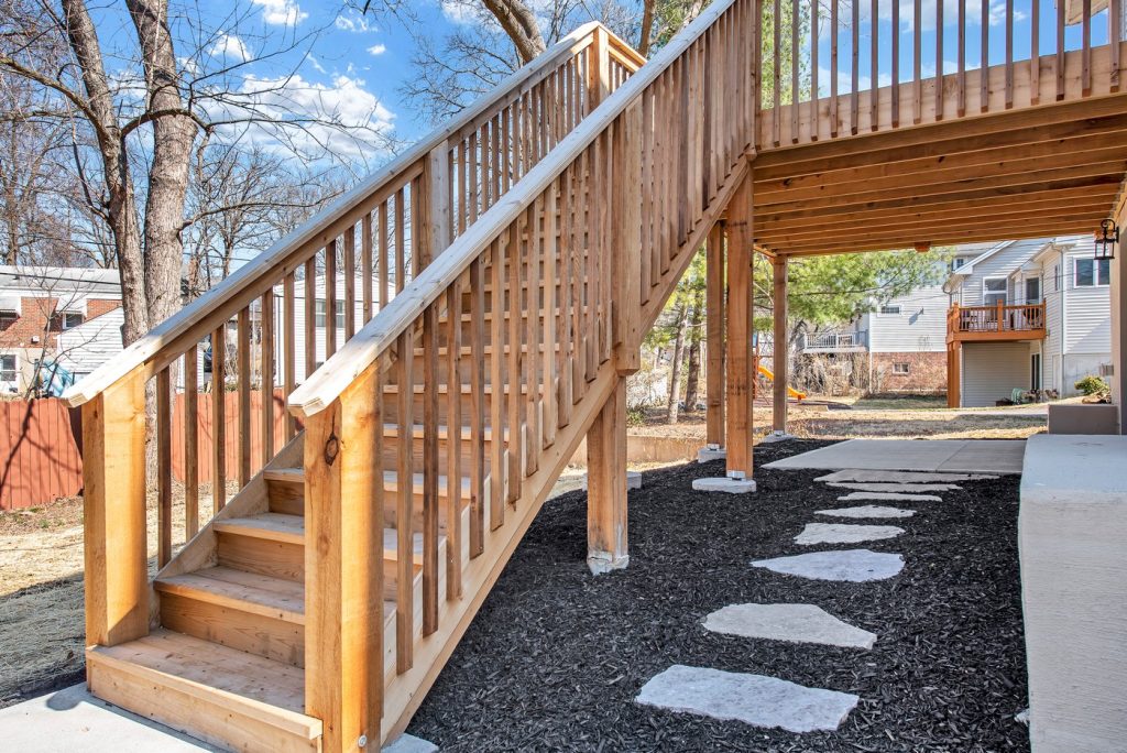 Cedar deck stairs above a stepping stone path