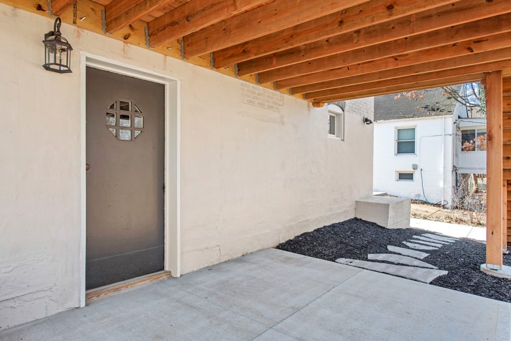 Covered patio beneath the deck with side entry