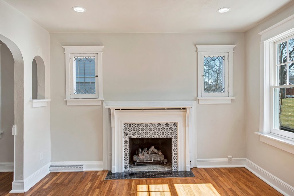 Tiled fireplace flanked by leaded glass windows
