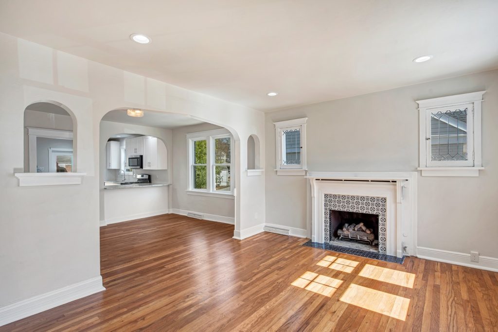 Living room fireplace with the kitchen visible beyond
