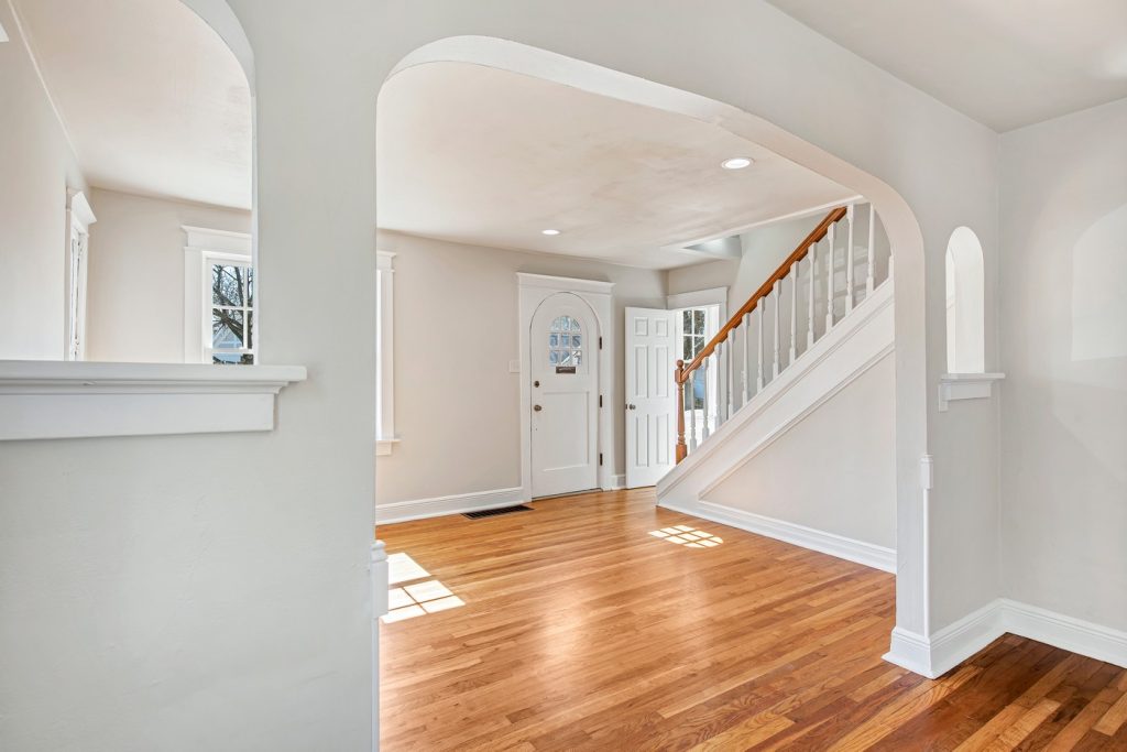 Entry hall with staircase and arched front door