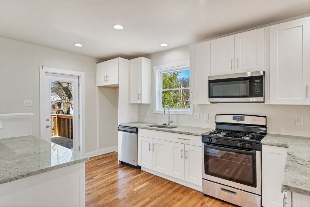 Kitchen sink and range beneath a yard window