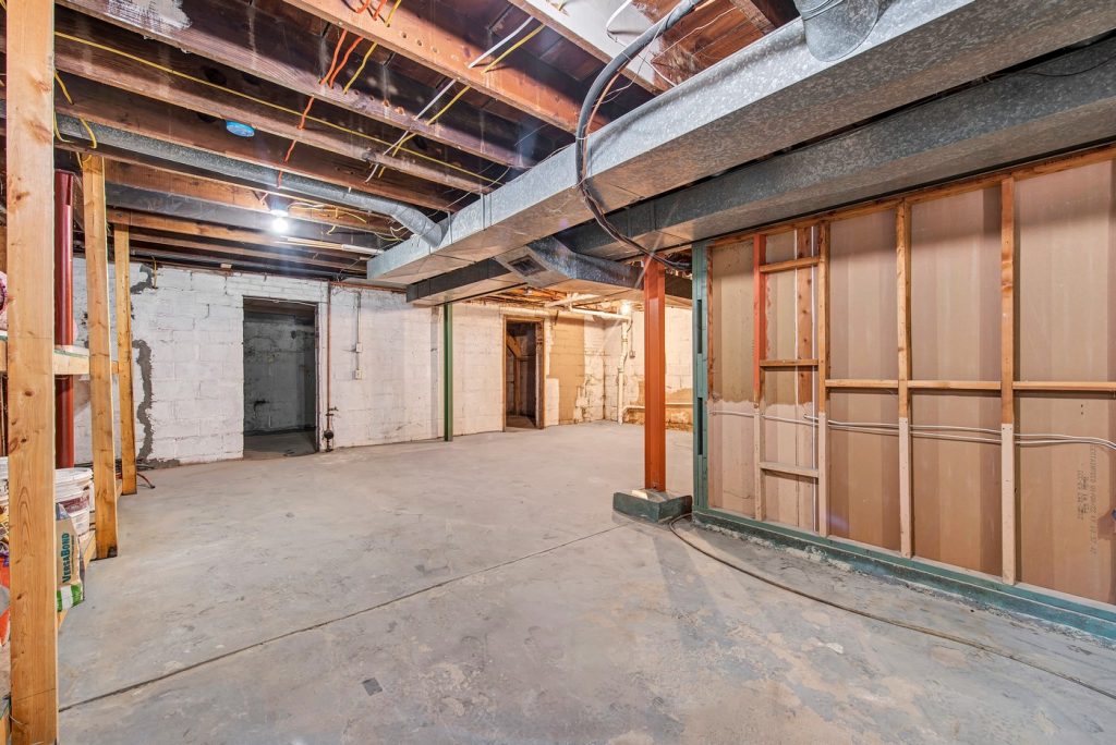 Unfinished basement showing framing and ductwork