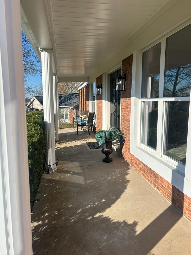 Covered front porch of a brick ranch home