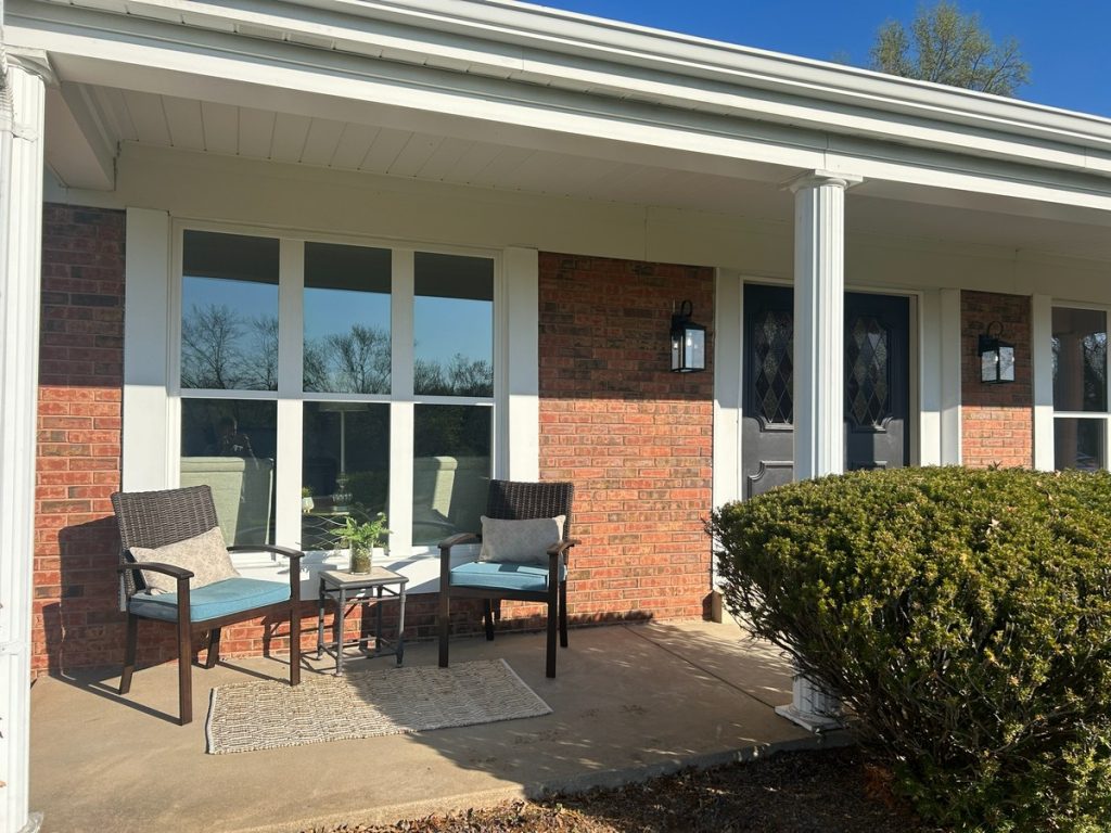 Brick home's front porch with columns and seating