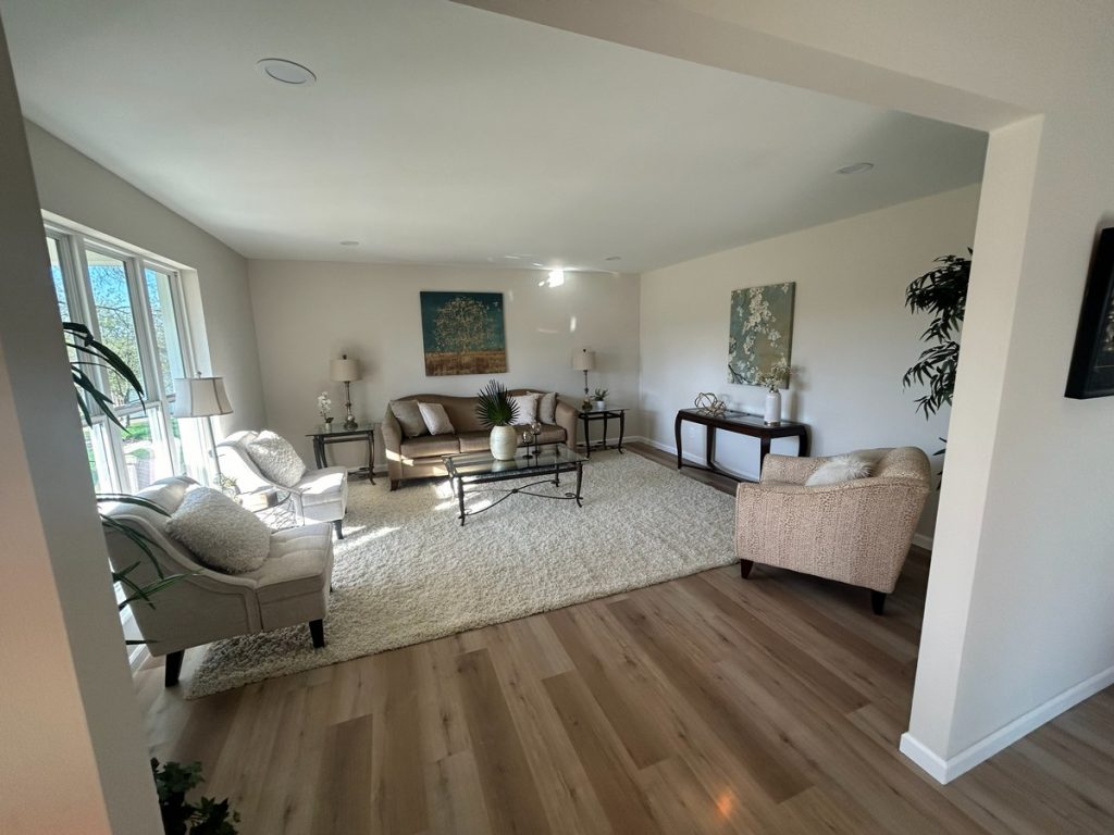 Staged living room with wide-plank wood flooring