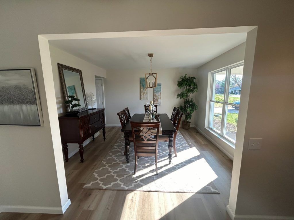 Dining room framed by a wide cased opening