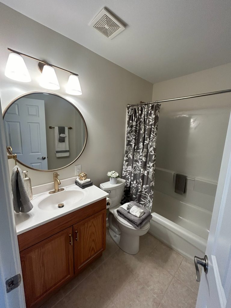 Bathroom with shower-tub combination and oak vanity
