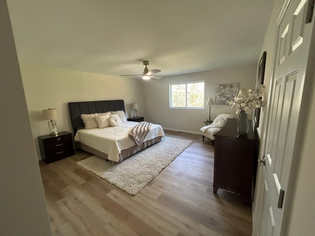 Bedroom with upholstered bed and ceiling fan