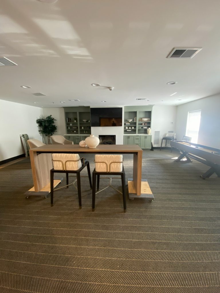 Resident lounge with high-top table and shuffleboard