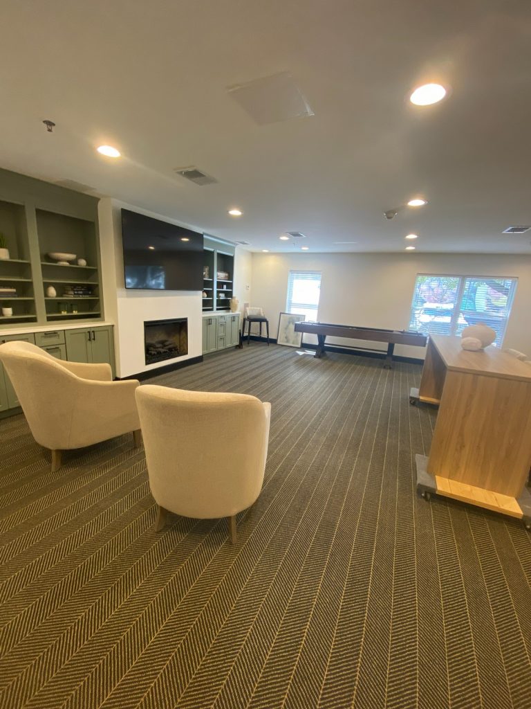 Armchairs facing the fireplace in the resident lounge