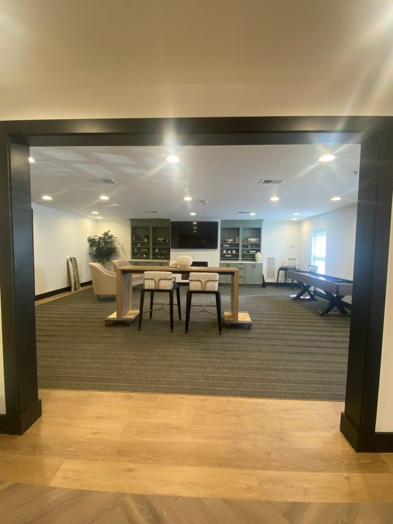Lounge viewed through a wide dark-trimmed opening