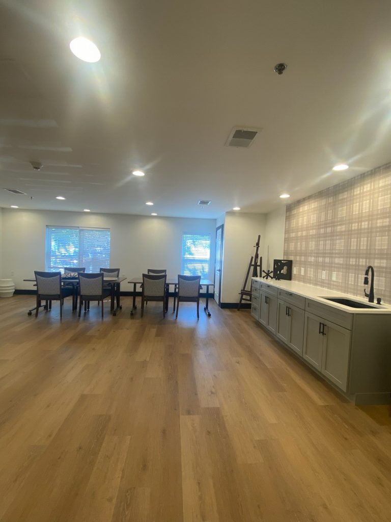 Activity room counter and sink beside the plaid wall