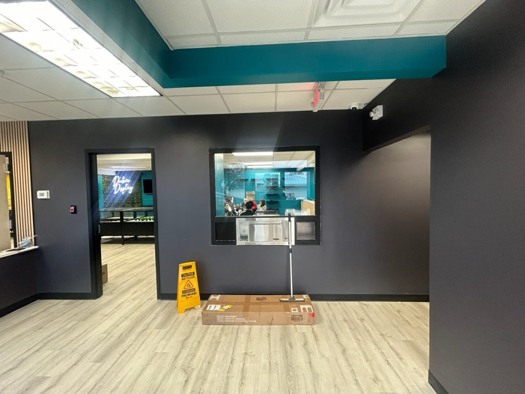 Interior with charcoal walls and a service window